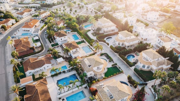 Drone aerial view to area with luxury houses, swimming pools and palm trees in Aya Napa, Cyprus on sunny summer day