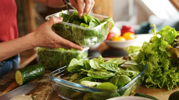 Girl Addin G A Fresh Spinach And Arugula To Fresh Vegetable Salad In The Bowl In The Kitchen, Concept Of Homemade Healthy Food