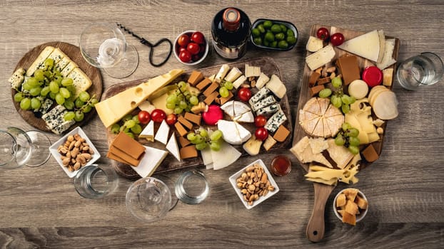 Variety of cheese kinds served with grape, honey and olives for gourmet nutrition. Organic parmesan, brie and camambert set with nuts