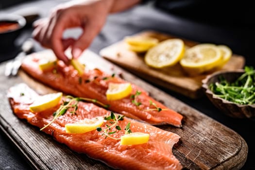 girl cooking fillet trout red fish with lemon and herbs in the kitchen