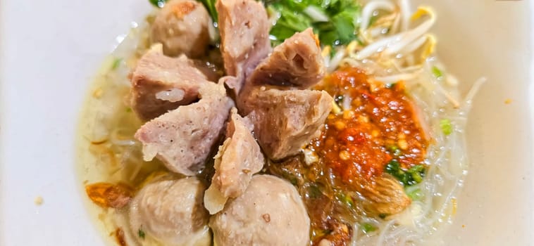 Bakso, indonesian meatball style served with beef broth soup and noodle springkled with fried onion and spring onion coupled with chili sauce on the top, very famous Asian street food