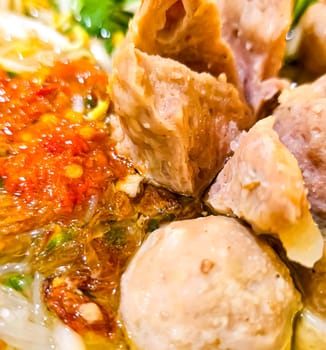 Bakso, indonesian meatball style served with beef broth soup and noodle springkled with fried onion and spring onion coupled with chili sauce on the top, very famous Asian street food