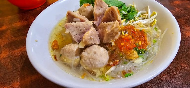 Bakso, indonesian meatball style served with beef broth soup and noodle springkled with fried onion and spring onion coupled with chili sauce on the top, very famous Asian street food