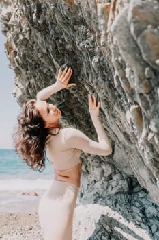 Happy young attractive brunette woman in red swimsuit, on the beach and sea background. Holiday vacation and travel concept.