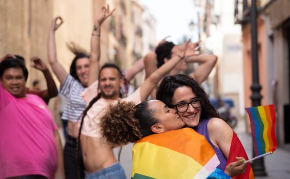 Happy LGBTQ community people enjoying and dancing on the gay parade MADO in Madrid city.