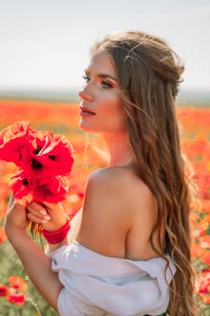 Woman poppies field. Side view of a happy woman with long hair in a poppy field and enjoying the beauty of nature in a warm summer day