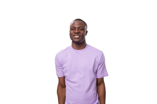 portrait of young smiling american man in lilac t-shirt isolated on white background with copy space.