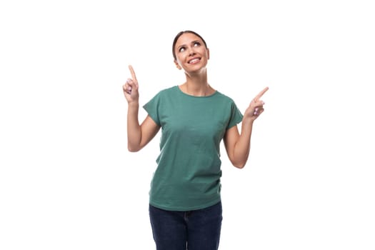 attractive young caucasian woman with black hair in a t-shirt actively gesturing on a white background with copy space. advertising concept.