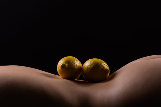 Lemon, natural vitamin c help skin whitening. Naked woman lying on back with fruit located