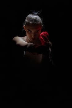 A strong punch with the fist straight ahead to the target. The athlete focused during training just before entering the ring boards.