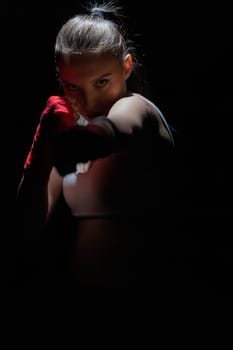 A strong punch with the fist straight ahead to the target. The athlete focused during training just before entering the ring boards.