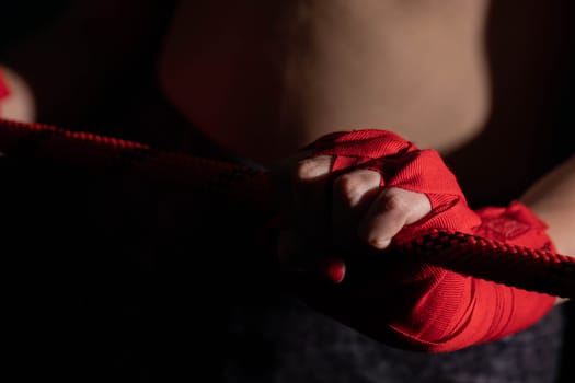 A tightly clenched hand on the boxing ring. A player strongly focused before her life fight .