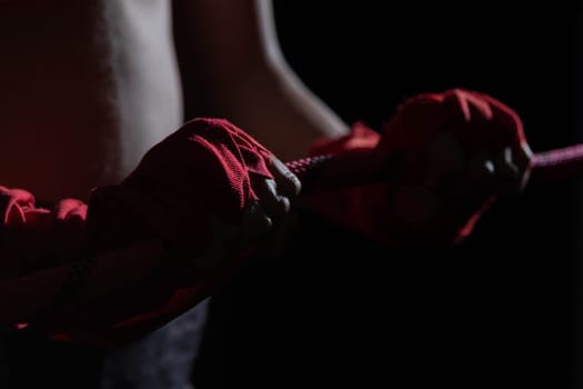 A tightly clenched hand on the boxing ring. A player strongly focused before her life fight .