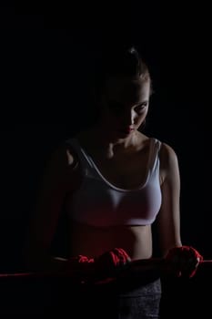 A tightly clenched hand on the boxing ring. A player strongly focused before her life fight .