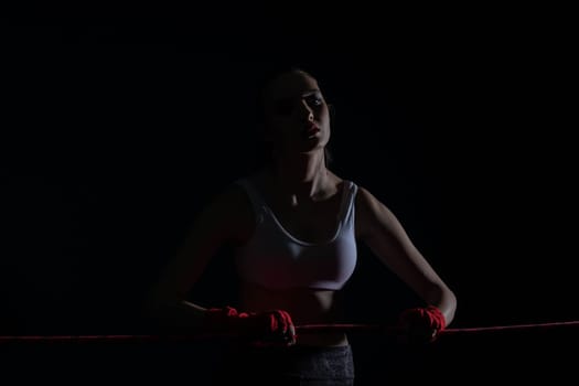 A tightly clenched hand on the boxing ring. A player strongly focused before her life fight .