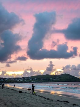 20 man are competing in a fishing competition on the beach