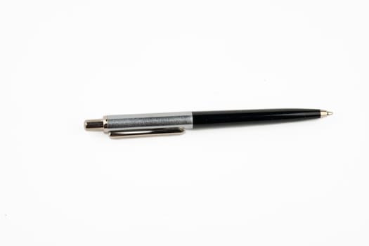 A pen highlighted on a white background with a ballpoint tip