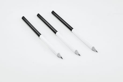 Black and white pencils with a dedicated copy space on a white background.