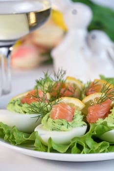 Eggs stuffed with avocado, salmon and lemon. Easter eggs. The perfect appetizer for your holiday table.