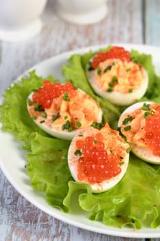 Stuffed eggs with salmon caviar are a popular appetizer for any occasion. Elegantly decorated and expertly seasoned, they will always be a beautiful appetizer at a party.