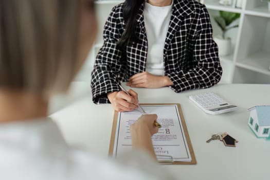 Real estate agent explain sale contract and home insurance to client.