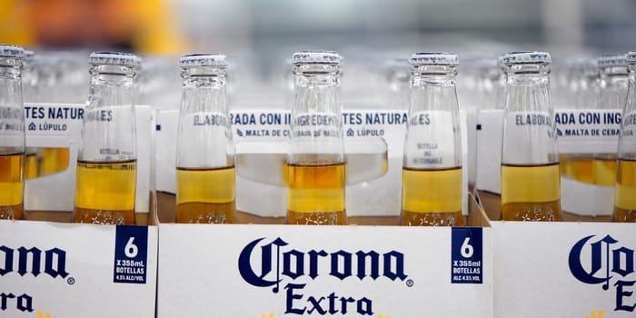 Corona Extra Beer sale, in beer boxes for 6 bottles, with handle. Pile of corona brand mexican beer boxes in a supermarket. Corona is the most popular imported beer in the USA. 20.02.2024, Armenia.