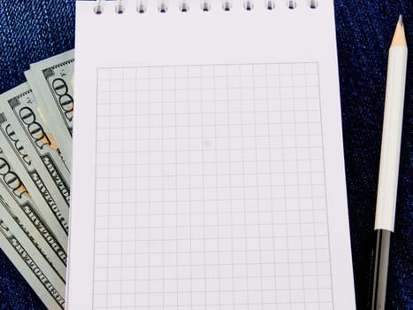 An empty notebook with space to write on the money