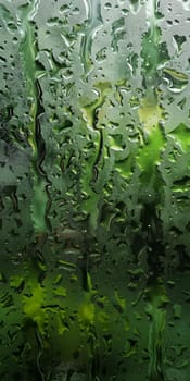 Close up of wet window with raindrops on it due to the bad weather.