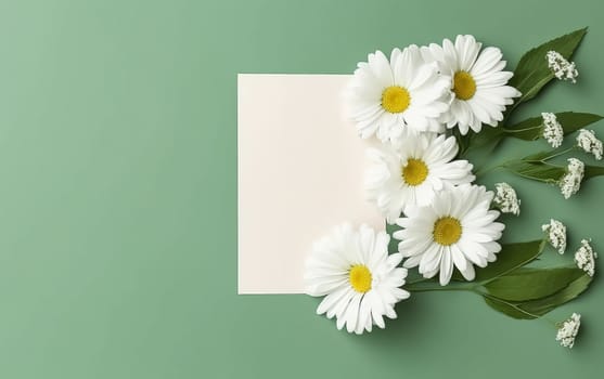 A white sheet of paper is placed on a green background with a bunch of white flowers. The flowers are arranged in a way that they are overlapping the paper, creating a sense of depth and dimension