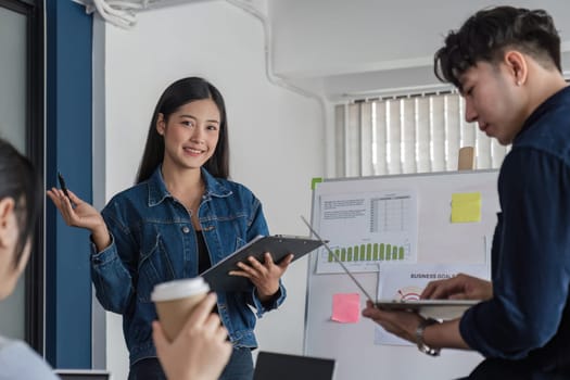 A team of accounting business people is having a brainstorming meeting to plan their work together in the company conference room..