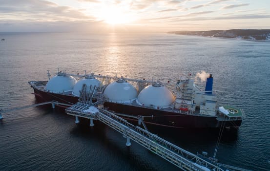 Aerial of Liquified Natural Gas LNG carrier moored to a small gas terminal. Fuel crisis. Sanctions.