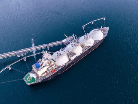 Aerial of Liquified Natural Gas LNG carrier moored to a small gas terminal. Fuel crisis. Sanctions.