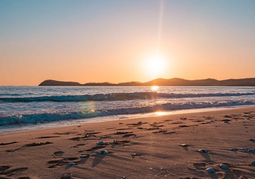 Sunset on the beach. Orange and golden sunset sky calmness tranquil relaxing sunlight summer mood.