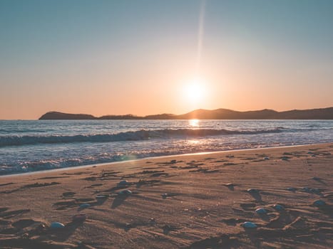 Sunset on the beach. Orange and golden sunset sky calmness tranquil relaxing sunlight summer mood.