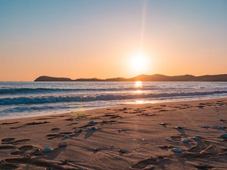 Sunset on the beach. Orange and golden sunset sky calmness tranquil relaxing sunlight summer mood.