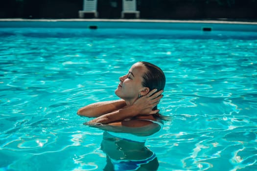 woman In bikini at swimming pool on a sunny day,bright tone,Fashion bikini pose concept