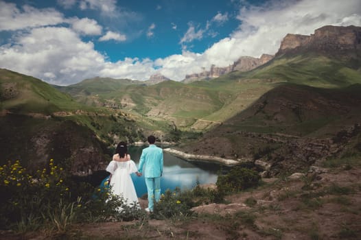 wedding couple at destination. Mountains and lake view. A picturesque place for a wedding.