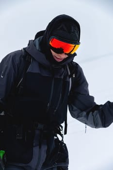 Portrait of a skier in safe ski equipment, standing and relaxing smiling while on vacation on the ski slope.