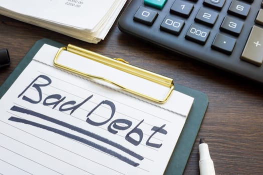 Bad debt concept. Financial report, a calculator and note paper.