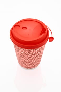 The pink cardboard coffee cup with a red plastic lid on the white glossy background, the inscription on the lid is Carefully Hot, transparent background. High quality photo