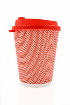 The pink cardboard coffee cup with a red plastic lid on the white glossy background, the inscription on the lid is Carefully Hot, transparent background. High quality photo