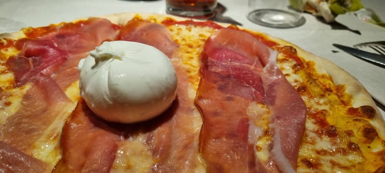 High-resolution image showcasing the detailed textures of a classic pizza with prosciutto and burrata cheese