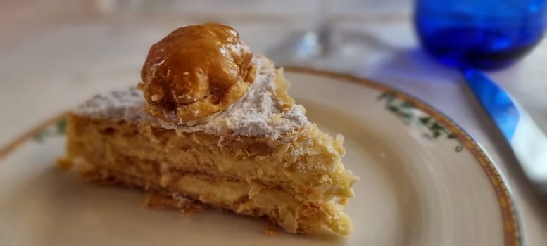 Close-up of a delicious napoleon pastry, also known as mille-feuille, served on a fine dining plate
