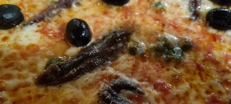 High-resolution image showcasing the details of a delicious anchovy and olive pizza topping