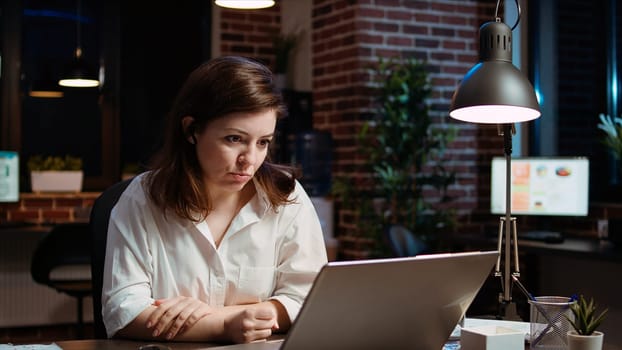 Employee calls manager remotely using internet videocall to ask for feedback on project progress. Worker in brick wall office requesting assistance from team leader in teleconference meeting, camera A