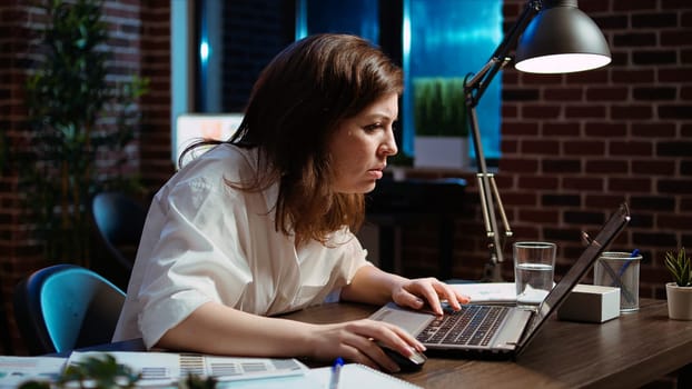 Employee upset by negative response received from customer while discussing business matters over email messages. Worker exasperated, putting head in head, frustrated by too much work in office