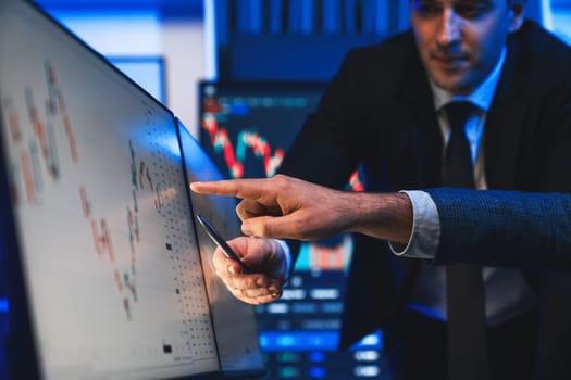 Stock traders pointing highest stock market on dynamic valued analysis on monitor real time screen, cooperating business investment in financial company to plan successful stock exchange. Sellable.