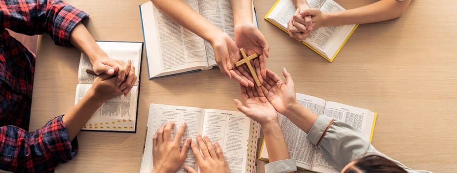 Close-up women prayer deliver holy bible book and holy cross to believer group. Spreading religion symbol. Concept of hope, religion, christianity and god blessing. Warm background. Burgeoning.