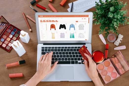 Woman shopping online on internet marketplace browsing for sale items for modern lifestyle and use credit card for online payment from wallet protected by utmost cyber security software