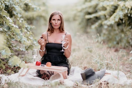 Picnic and wine tasting at sunset in the hills of Italy, Tuscany. Vineyards and open nature in the summer. Romantic dinner, fruit and wine.